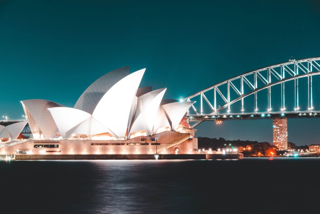 Sydney Opera House beside the harbour at night